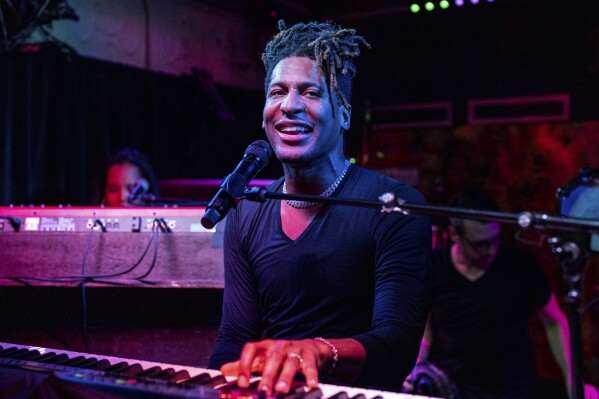 FILE - Jon Batiste performs at the Maple Leaf Bar in New Orleans on May 2, 2023. The singer-songwriter and multi-instrumentalist releases his latest album “World Music Radio” on Aug. 18. (Photo by Amy Harris/Invision/AP, File)