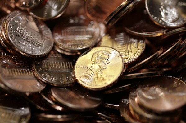 Freshly-made pennies sit in a bin at the U.S. Mint in Denver on Aug. 15, 2007. (AP Photo/David Zalubowski, File)