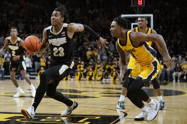 Purdue guard Jaden Ivey (23) dries to the basket ahead of Iowa guard Ahron Ulis, right, during the first half of an NCAA college basketball game, Thursday, Jan. 27, 2022, in Iowa City, Iowa. (AP Photo/Charlie Neibergall)