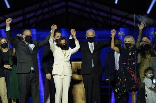 From left, Doug Emhoff, husband of Vice President-elect Kamala Harris, Harris, President-elect Joe Biden and his wife Jill Biden on stage together, Saturday, Nov. 7, 2020, in Wilmington, Del. (AP Photo/Andrew Harnik, Pool)