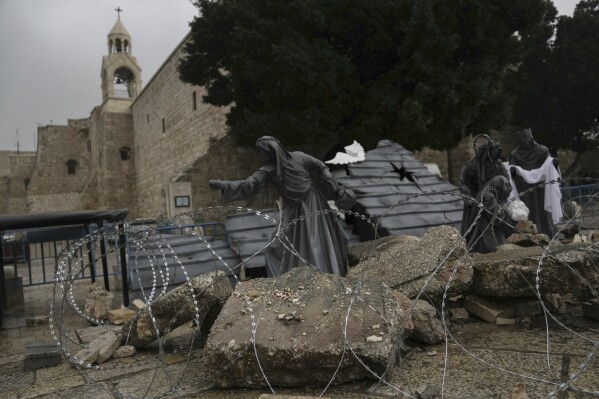 A nativity scene decorated to honor the victims in Gaza is displayed in Manger Square, near the Nativity Church, which is traditionally believed to be the birthplace of Jesus, on Christmas Eve, in the West Bank city of Bethlehem, Sunday, Dec. 24, 2023. Bethlehem is having a subdued Christmas after officials in Jesus' traditional birthplace decided to forgo celebrations due to the Israel-Hamas war. (AP Photo/Mahmoud Illean)