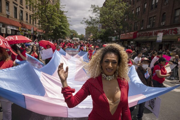 Participants hold a large transgender flag during the 31st annual Queens Pride Parade and Multicultural Festival, Sunday, June. 4, 2023, in New York. Transgender and nonbinary people are front and center this year at Pride festivals where they've often been sidelined. (AP Photo/Yuki Iwamura)