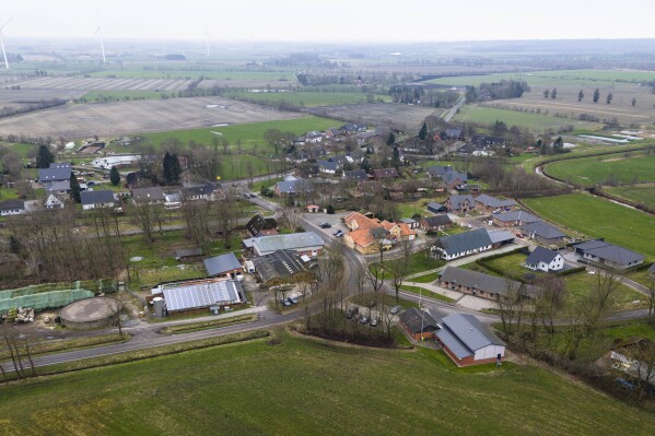 The village Sprakebuell, Germany, is shown in an aerial photo taken Thursday, March 14, 2024. Sprakebuell is something of a model village for the energy transition - with an above-average number of electric cars, a community wind farm and renewable heat from biogas. All houses in the village center have been connected to the local heating network and all old oil heating systems have been removed. (AP Photo/Frank Molter)