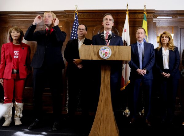 
              Los Angeles Mayor Eric Garcetti, center at podium, listens to a question during a news conference in Los Angeles after a tentative deal was reached Tuesday, Jan. 22, 2019. Arlene Inouye, from left, team chair with the United Teachers Los Angeles, Justin Maurer, sign language interpreter, Union President Alex Caputo-Pearl, Austin Beutner, Superintendent of the Los Angeles Unified School District, and Vivian Ekchian, deputy superintendent stand in the background. A tentative deal was reached Tuesday between Los Angeles school officials and the teachers union that will allow educators to return to classrooms after a six-day strike against the nation's second-largest district, officials said. (AP Photo/Richard Vogel)
            