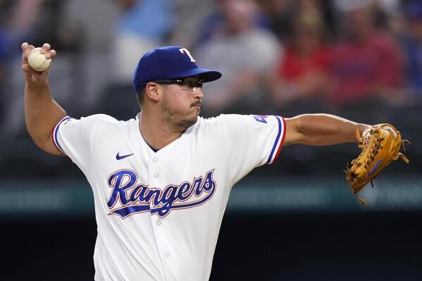 Texas Rangers starting pitcher Dane Dunning throws during the first inning of the team's baseball game against the Chicago White Sox in Arlington, Texas, Saturday, Aug. 6, 2022. (AP Photo/LM Otero)