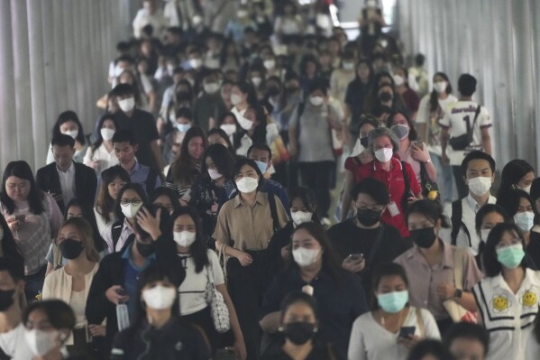 Peoples wear face masks to protect themselves from air pollution in Bangkok, Thailand, Feb. 6, 2025, (AP Photo/Sakchai Lalit, File)