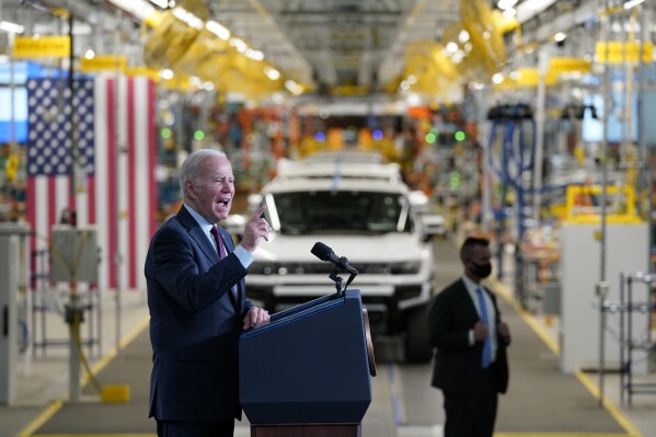 FILE - President Joe Biden speaks during a visit to the General Motors Factory ZERO electric vehicle assembly plant, Nov. 17, 2021, in Detroit. The Biden administration this week is expected to announce new automobile emissions standards that relax proposed limits in the next few years but reach the same strict standards outlined by the Environmental Protection Agency last year. (AP Photo/Evan Vucci, File)