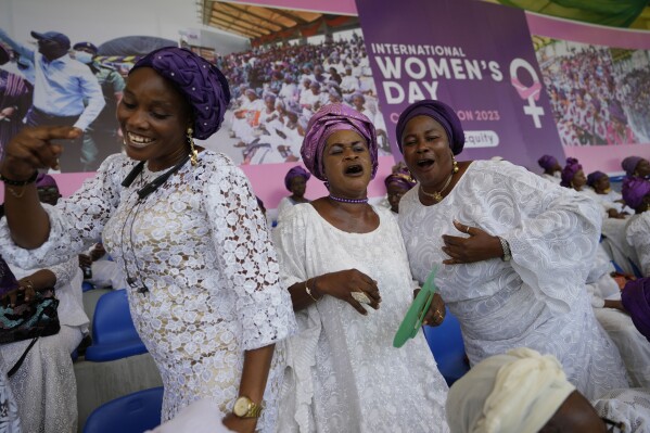 Women sing and dance during the International Women's Day celebration at the Mobolaji Johnson Stadium in Lagos, Nigeria, Wednesday, March 8, 2023. (AP Photo/Sunday Alamba)