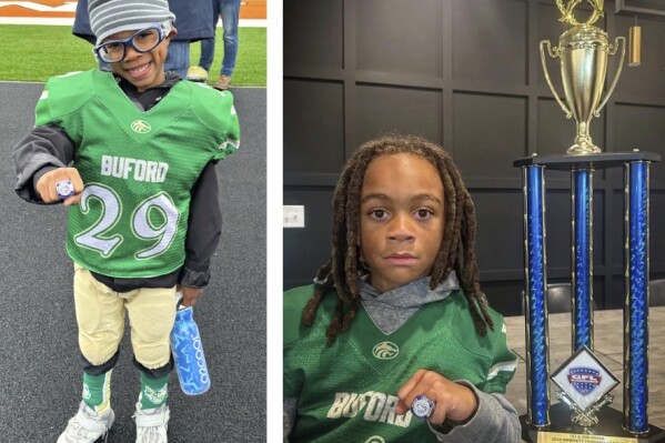 These photos, courtesy of the Williams and Webb families, show seven-year-olds Christopher Williams, left, of Flowery Branch, Ga., and Micáias Webb, right, of Buford, Ga., showing off their championship rings after the Buford Webb youth football team won the Gwinnett Football League championship Nov. 11, 2023, in Gwinnett County, Ga. Buford, Georgia excels at producing football talent. Concerns about the potential for brain disease related to repeated blows to the head have turned off some parents. But passion for the sport is undiminished in this Atlanta suburb. (Photos courtesy of Williams and Webb Families)