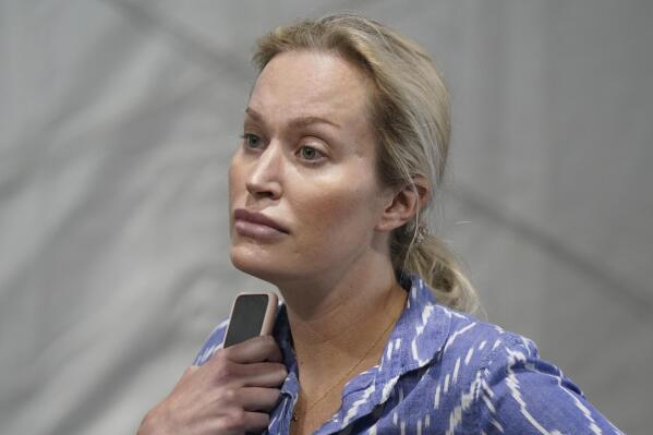FILE - Christina Pushaw, press secretary for Florida Gov. Ron DeSantis, listens during a press conference Aug. 18, 2021, in Pembroke Pines, Fla. Hateful references to gays, lesbians and other LGBTQ Americans on social media surged following Florida's adoption of a law restricting how teachers can talk about sexual orientation with younger students. Influential conservatives including Pushaw drove much of the increase, the researchers found, through their own posts or by liking or forwarding posts from others. (AP Photo/Marta Lavandier, File)