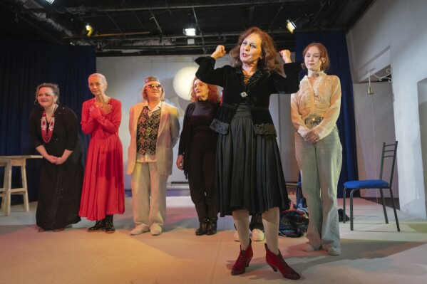 Actresses thank spectators on the stage of the Chernihiv Regional Youth Theater, which reinvented itself with an all-female cast, with most male actors at war, in Chernihiv, Ukraine, Sunday, Feb. 16, 2025. (AP Photo/Efrem Lukatsky)