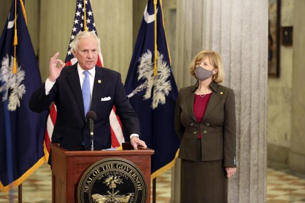 FILE - In this Thursday, Feb. 4, 2021, file photo, South Carolina Gov. Henry McMaster, left, and state Education Superintendent Molly Spearman, right, talk about a Senate proposal to get teachers COVID-19 vaccines immediately, in Columbia, S.C. A budget proviso that went into effect July 1 prohibits school districts in South Carolina from using appropriated funds “to require that its students and/or employees wear a face mask at any of its education facilities.” The measure was backed by Gov. McMaster.  (AP Photo/Jeffrey Collins, File)