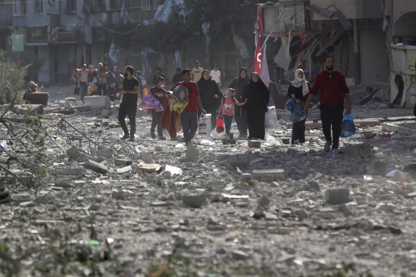 Palestinians leave their homes following Israeli bombardment on Gaza City, Monday, Oct. 30, 2023. (AP Photo/Abed Khaled)