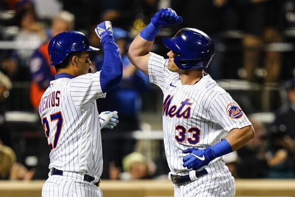 New York Mets' Mark Vientos celebrates with James McCann (33) after they scored on a three-run home run by McCann during the third inning of a baseball game against the Washington Nationals, Wednesday, Oct. 5, 2022, in New York. (AP Photo/Frank Franklin II)