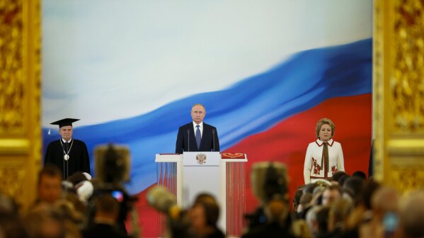 Vladimir Putin, center, speaks during his inauguration ceremony for a new term as Russia's president, with Constitutional Court Chairman Valery Zorkin, left, and Valentina Matviyenko, speaker of the Federation Council, Russian parliament's upper chamber, right, next to him in the Grand Kremlin Palace in Moscow, Russia, Monday, May 7, 2018. Putin took the oath of office for his fourth term as Russian president on Monday and promised to pursue an economic agenda that would boost living standards across the country. (AP Photo/Alexander Zemlianichenko, Pool)
