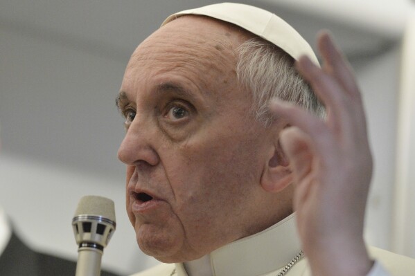 Pope Francis talks about gays saying he wouldn't judge priests for their sexual orientation in a remarkably open and wide-ranging news conference aboard the papal flight on the journey back from Brazil, on July 29, 2013. (AP Photo/Luca Zennaro, Pool, file)