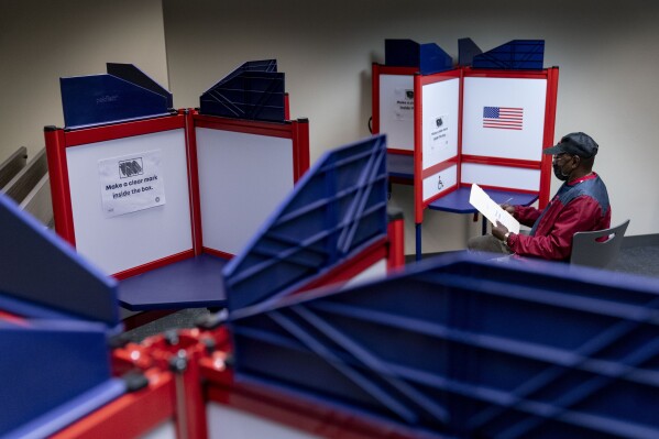 FILE - Cornelius Whiting fills out his ballot at an early voting location in Alexandria, Va., on Sept. 26, 2022. The Associated Press is making some of its U.S. elections data available for free to more than 400 nonprofit news organizations in a program funded by the Google News Initiative, the company said on Wednesday, Feb. 14, 2024. (AP Photo/Andrew Harnik, File)