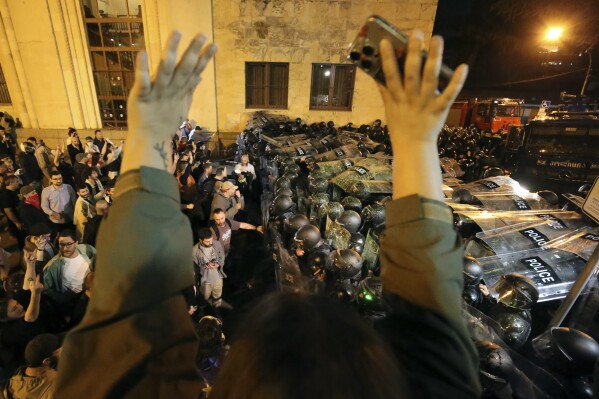 Police block protestors gathered outside the parliament building in Tbilisi, Georgia, on Tuesday, April 16, 2024, to protest against 
