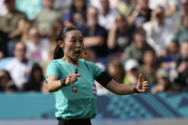 FILE - Referee Yoshimi Yamashita gives directions to players during the Women's World Cup round of 16 soccer match between the Netherlands and South Africa at the Sydney Football Stadium in Sydney, Australia, on Aug. 6, 2023. Soccer referee Yoshimi Yamashita is returning to Qatar to make more soccer history at the men’s Asian Cup in January. She also worked there last year at the men’s World Cup in the first wave of women match officials picked by FIFA. The Asian Football Confederation has picked Yamashita and Katherine Jacewicz of Australia among the referees. (AP Photo/Mark Baker)