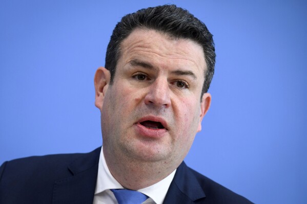 Federal Minister of Labor and Social Affairs Hubertus Heil informs the Federal Press Conference about planned measures for labor market integration, in Berlin, Germany, Wednesday Oct. 18, 2023. The German government has announced a drive to get more Ukrainian and other refugees into jobs now that many have a usable knowledge of the German language. (Bernd von Jutrczenka/dpa via AP)