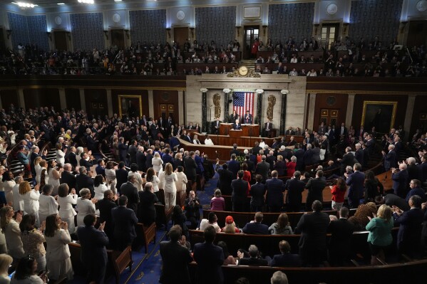 Both Democrats and Republicans stand to applaud as President Joe Biden speaks about former Rep. John Lewis, as he delivers the State of the Union address to a joint session of Congress at the U.S. Capitol, Thursday March 7, 2024, in Washington. (AP Photo/Andrew Harnik)