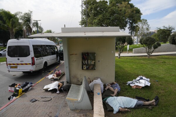 Civilians killed by Palestinian militants lie covered in Sderot, Israel, on Saturday, Oct. 7, 2023. Palestinian militants in the Gaza Strip infiltrated Saturday into southern Israel and fired thousands of rockets into the country while Israel began striking targets in Gaza in response. (AP Photo/Ohad Zwigenberg)