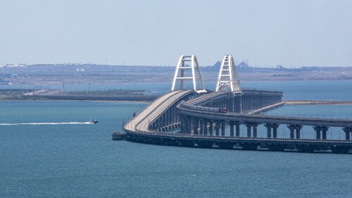 A freight train runs on rails of a railway link of the Crimean Bridge connecting Russian mainland and Crimean peninsula over the Kerch Strait not far from Kerch, Crimea, on Monday, July 17, 2023. An attack before dawn damaged part of a bridge linking Russia to Moscow-annexed Crimea that is a key supply route for Kremlin forces in the war with Ukraine. The strike Monday has forced the span's temporary closure for a second time in less than a year. (AP Photo)