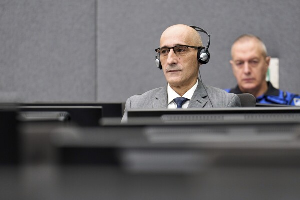 Salih Mustafa sits at a special Kosovo court in The Hague, Netherlands, Thursday, Dec. 14, 2023. Appeals judges at a special Kosovo court in the Netherlands were ruling Thursday in case of a former commander in the Kosovo Liberation Army who was convicted a year ago for arbitrarily detaining and torturing prisoners and murdering one of them during a late 1990s war for Kosovo’s independence. (AP Photo/Phil Nijhuis, Pool)