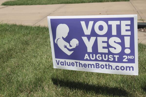 FILE - In this photo from Friday, July 8, 2022, a sign in a yard in Olathe, Kansas, promotes a proposed amendment to the Kansas Constitution to allow legislators to further restrict or ban abortion. Supporters call the measure "Value Them Both," arguing that it protects both unborn children and the women carrying them. Alabama, Arizona, Georgia, Kansas and Missouri all have personhood laws. (AP Photo/John Hanna, File)