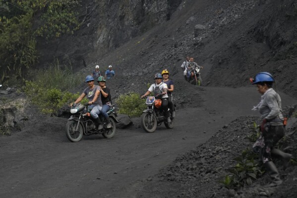 Emerald miners arrive on motorbikes to an informal mine near the town of Coscuez, Colombia, Thursday, Feb. 29, 2024. Some of the biggest emeralds in the world have been mined in Colombia, including one weighing 3 pounds (1.36 kilograms) that broke the world record in 1995. (AP Photo/Fernando Vergara)