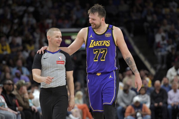 Los Angeles Lakers guard Luka Doncic (77) talks with referee Tyler Ford in the second half of an NBA basketball game against Memphis Grizzlies Saturday, March 29, 2025, in Memphis, Tenn. (AP Photo/Brandon Dill,File)