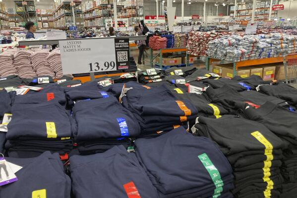 FILE - Clothing sits on tables for shoppers in a Costco warehouse Monday, Aug. 29, 2022, in Sheridan, Colo. The Federal Reserve is expected to raise its key short-term rate by a substantial three-quarters of a point for the third consecutive time Wednesday, Sept. 21. The goal is to slow consumer spending, reducing demand for homes, cars and other goods and services, eventually cooling the economy and lowering prices. (AP Photo/David Zalubowski)