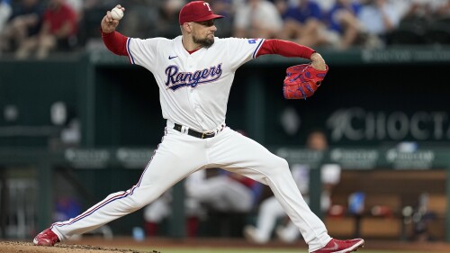 Texas Rangers starting pitcher Nathan Eovaldi throws to a Tampa Bay Rays batter during the third inning of a baseball game Tuesday, July 18, 2023, in Arlington, Texas. (AP Photo/Tony Gutierrez)