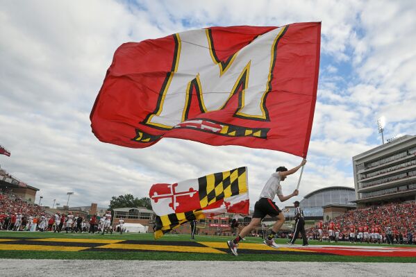 The Maryland state flag and University of Maryland flag are run across the end zone after a touchdown during the first half of an NCAA college football game between Maryland and Indiana, Saturday, Sept. 30, 2023, in College Park, Md. (AP Photo/Terrance Williams, File)