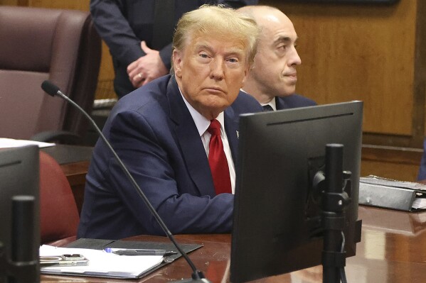 Donald Trump awaits the start of a hearing in New York City Criminal Court, Thursday, February 15, 2024. A New York judge says former President Donald Trump's hush-money trial will go ahead as scheduled with jury selection starting on March 25. (Jefferson Siegel for The New York Times via AP, Pool)