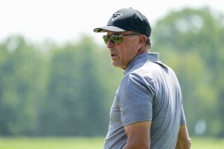 FILE - Phil Mickelson warms up on the driving range ahead of the first round of the Bedminster Invitational LIV Golf tournament in Bedminster, N.J., Aug. 11, 2023. Mickelson posted on social media Monday, Sept. 18, 2023, that he is not gambling on football this year and is in recovery from his addiction. (AP Photo/Mary Altaffer, File)