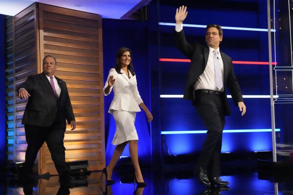 FILE - Republican presidential candidates from left, former New Jersey Gov. Chris Christie, former UN Ambassador Nikki Haley, and Florida Gov. Ron DeSantis, arrive on stage before a Republican presidential primary debate hosted by NBC News Wednesday, Nov. 8, 2023, at the Adrienne Arsht Center for the Performing Arts of Miami-Dade County in Miami. A two-hour Republican presidential primary debate will start at 8 p.m. ET on Wednesday, Dec. 6, in Tuscaloosa, Ala. (AP Photo/Wilfredo Lee, File)