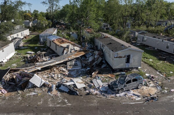 Storm damaged mobile homes are surrounded by debris at Pavilion Estates mobile home park just east of Kalamazoo, Mich. Wednesday, May 8, 2024. A tornado ripped through the area the evening of May 7. (Neil Blake/The Grand Rapids Press via AP)