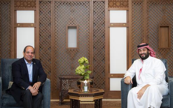 In this photo provided by the Saudi Royal Palace, Saudi Crown Prince Mohammed bin Salman, right, meets with Egyptian President Abdel-Fattah el-Siss in Jeddah, Saudi Arabia, late Sunday, April 2, 2023. (Bandar Aljaloud/Saudi Royal Palace via AP)
