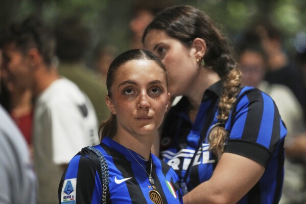 Inter Milan fans react as they watch their team play PSG in the Champions League final soccer match in open pub in Milan, Italy, Saturday, May 31, 2025. (AP Photo/Antonio Calanni)