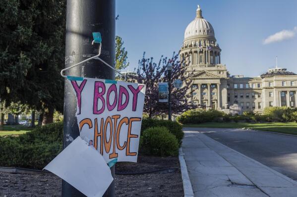 FILE - A sign reading "My body, my Choice," is taped to a hanger taped to a streetlight in front of the Idaho State Capitol Building on May 3, 2022. The Idaho Supreme Court ruled on Friday, Aug. 12, that the state's strict abortion bans will be allowed to take effect while legal challenges over the laws play out in court. (Sarah A. Miller/Idaho Statesman via AP, File)