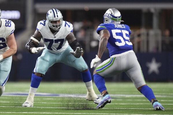 FILE - Dallas Cowboys offensive tackle Tyron Smith (77) prepares to make a block on Seattle Seahawks defensive end Dre'Mont Jones (55) during an NFL football game Nov. 30, 2023, in Dallas. The New York Jets agreed to terms on a one-year contract with Smith, a person familiar with the deal told The Associated Press. The move Friday, March 15, completes an overhaul of New York's offensive line, the focus of the offseason for the Jets and general manager Joe Douglas. (AP Photo/Peter Joneleit, File)