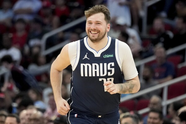 Dallas Mavericks guard Luka Doncic smiles after making a basket against the Houston Rockets during the second half of an NBA basketball game Sunday, March 31, 2024, in Houston. (AP Photo/Eric Christian Smith)