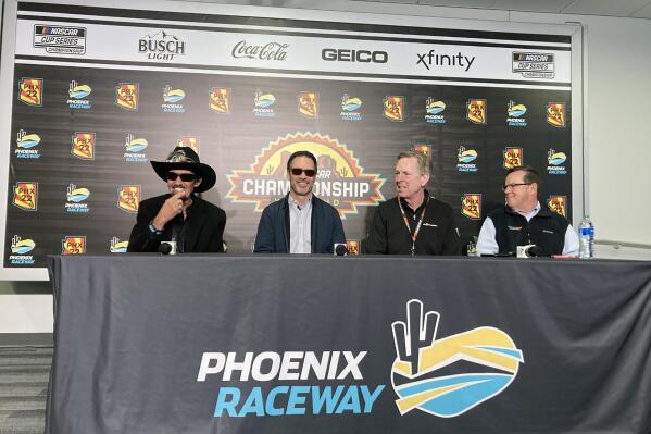FILE - Richard Petty, from left, Jimmie Johnson, Maury Gallagher, and Petty GMS team president Mike Beam, attend a press conference at Phoenix Raceway in Avondale, Ariz., Friday, Nov. 4, 2022. Jimmie Johnson on Wednesday, Jan. 11, 2023, revealed his rebranded NASCAR team and said he will drive the No. 84 — the opposite of his synonymous No. 48 — when the seven-time champion competes for Legacy Motor Club. (AP Photo/Jenna Fryer, File)