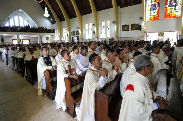 Catholic priests attend the ordination ceremony of Paulus Budi Kleden as the new bishop of Ende, at the Christ the King Cathedral church in Ende, East NusaTenggara province, Indonesia, Thursday, Aug. 22, 2024. (AP Photo/Tatan Syuflana)