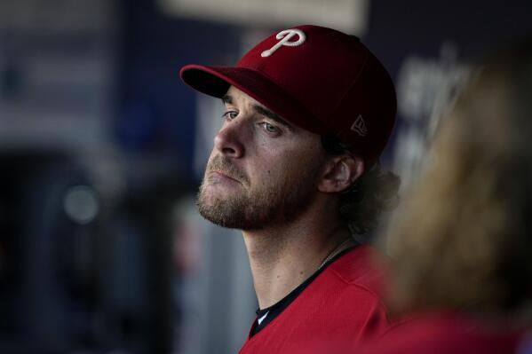 Philadelphia Phillies starting pitcher Aaron Nola sits in the dugout during the sixth inning in Game 2 of the baseball NL Championship Series between the San Diego Padres and the Philadelphia Phillies on Wednesday, Oct. 19, 2022, in San Diego. (AP Photo/Gregory Bull)