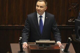 Poland's President Andrzej Duda speaks to parliament members after he had been sworn in for a second term, at the parliament, in Warsaw, Poland, on Thursday, August 6, 2020. Many of Poland's former leaders abstained from the ceremony to show disapproval for his first term policies.(AP Photo/Czarek Sokolowski)