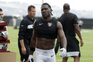 FILE - In this Aug. 20, 2019, file photo, Oakland Raiders' Antonio Brown walks off the field after NFL football practice in Alameda, Calif. Coach Jon Gruden says star receiver Antonio Brown is back with the team and is expected to play the season opener on Monday, after a run-in with general manager Mike Mayock put him in jeopardy of being suspended. (AP Photo/Jeff Chiu, File)