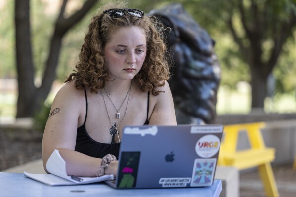 Stella Gage, 19, a sophomore psychology and sociology major at Wichita State University, studies on the campus in Wichita, Kan., Sept. 26, 2023. As public schools in the U.S. are faced with new guidelines and laws around health and sex education, many queer students are recalling their experience and what they hope to see taught in their classrooms. (AP Photo/Travis Heying)
