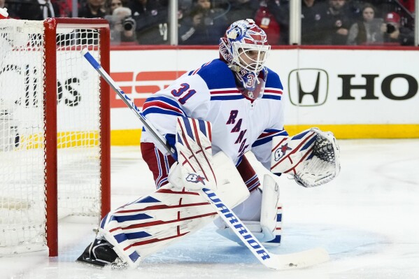 FILE - New York Rangers goaltender Igor Shesterkin watches the puck during the second period of Game 5 of the team's NHL hockey Stanley Cup first-round playoff series against the New Jersey Devils, Thursday, April 27, 2023, in Newark, N.J. The Rangers season opens Oct. 12 at Buffalo.(AP Photo/Frank Franklin II, File)